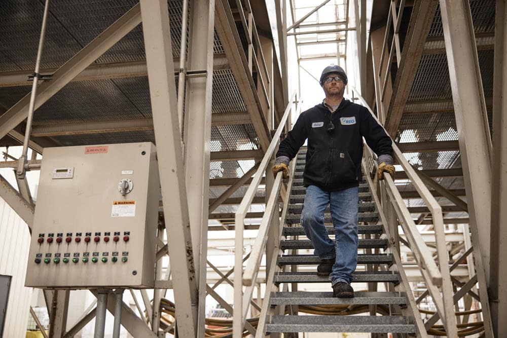 Chevron plant employee walking down stairs